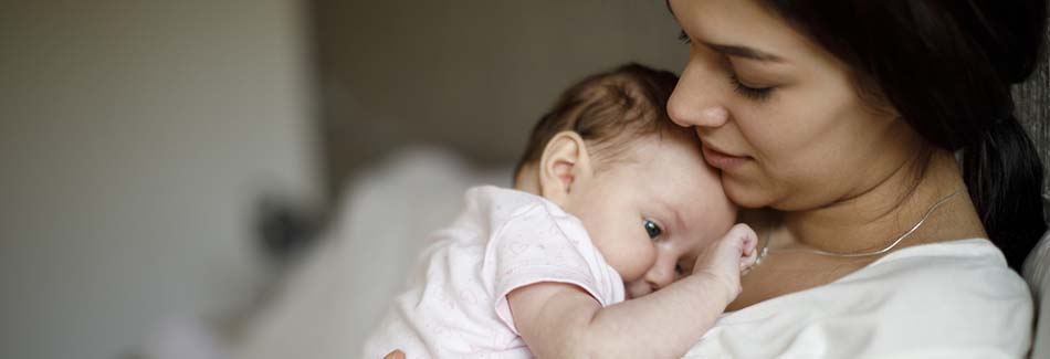 A woman holds a newborn in a birthing center at Baptist’s labor and delivery hospital