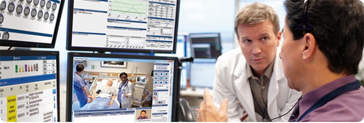Baptist TeleHealth team monitoring patient vitals on multiple screens in the TeleGuardian eICU center