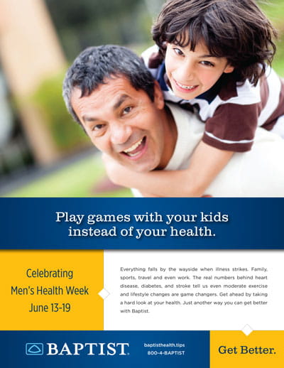 Man gives a piggyback ride to a smiling boy in a bright, grassy yard; both laughing and playful.